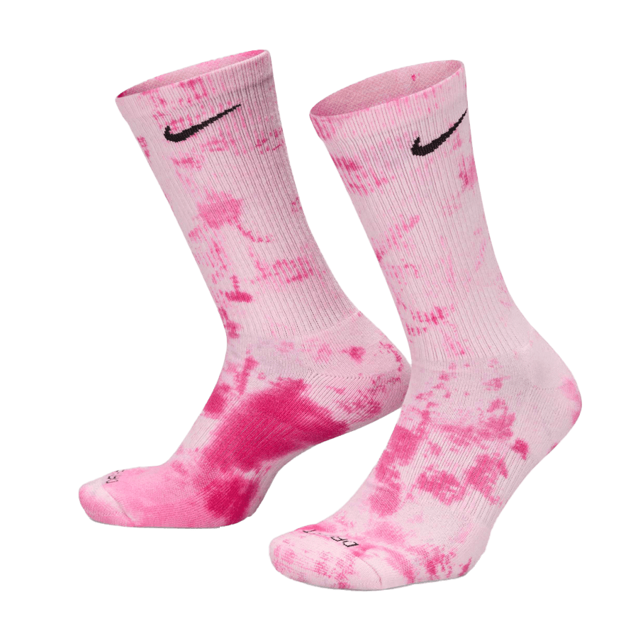 A pair of Nike Everyday Plus Tie-Dye Socks in pink with black swoosh logos near the top. They are positioned upright, displaying both the front and heel.