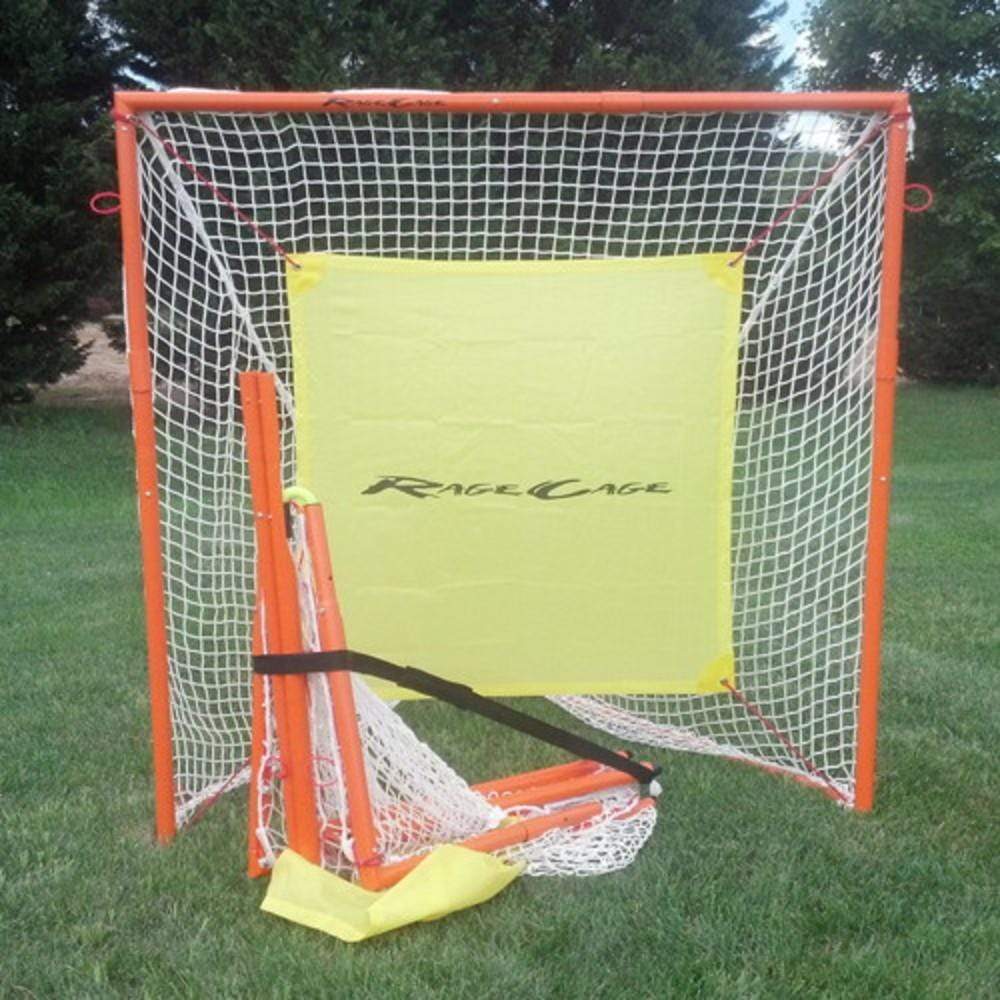 A Rage Cage 5x5 goal with an orange frame and white netting is set up on a grassy area. In front of the goal, additional pieces of frame and netting are partially assembled. The goal has a yellow target area with the text "RageCage" printed on it.